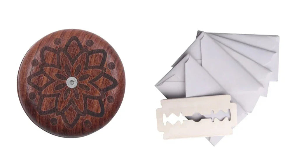Wooden product with intricate design, white razor, and gray folded paper on a white background