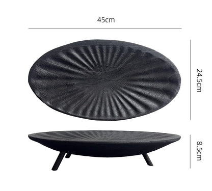 Black textured round object with dimensions on a white background