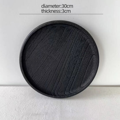 Black round coaster with measurements on a white background