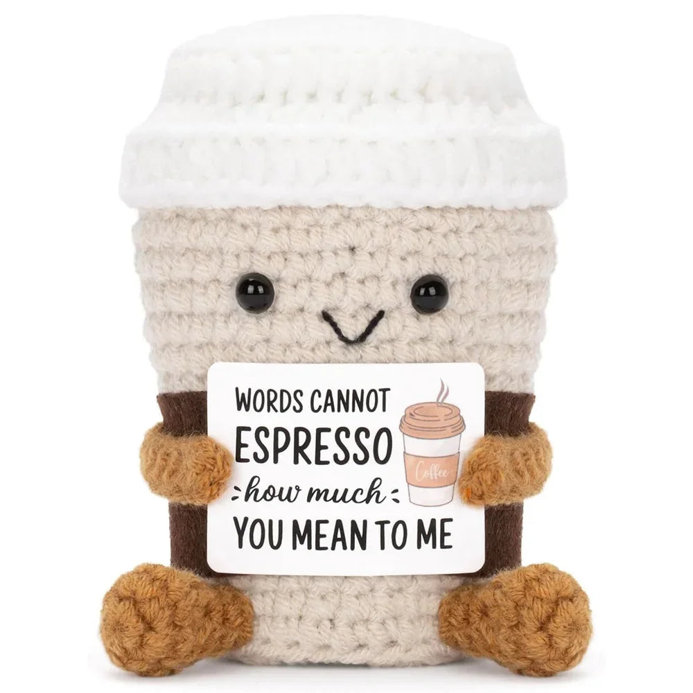 Crocheted coffee cup plush toy with a humorous message on a white background