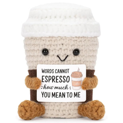 Crocheted coffee cup plush toy with a humorous message on a white background