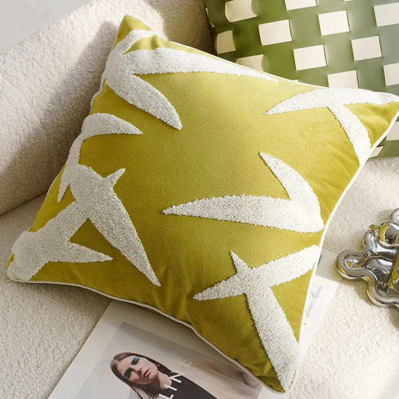 Green pillow with white star patterns on a beige surface