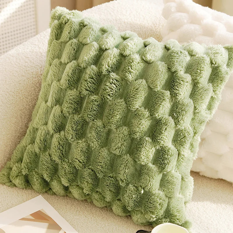 Green textured pillow on a beige couch