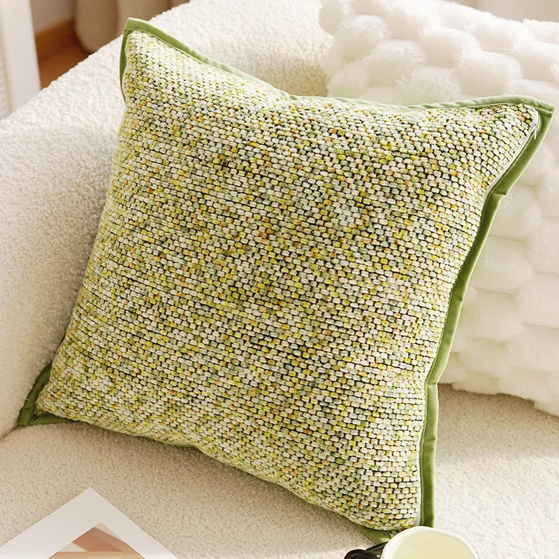 Green textured pillow on a beige sofa