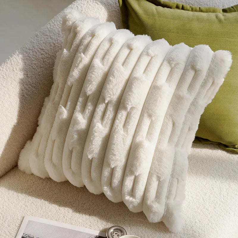 White textured pillow on a beige sofa with a green cushion in the background