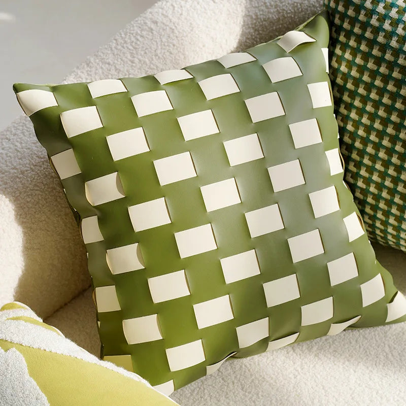 Green and white checkered pillow on a couch