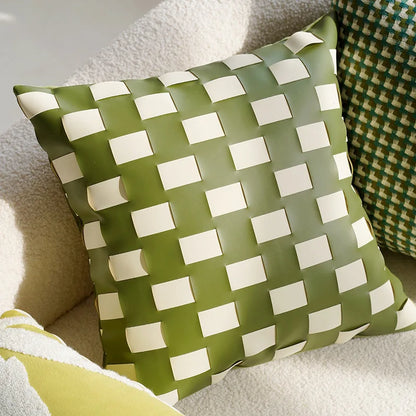 Green and white checkered pillow on a couch