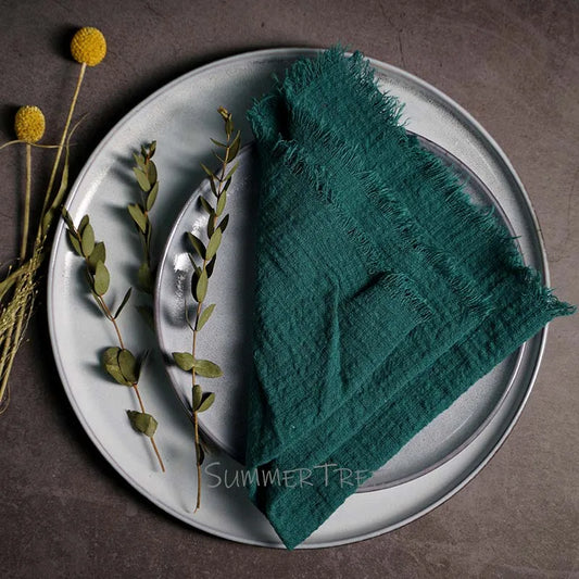 Green napkin on a white plate with decorative elements on a brown background
