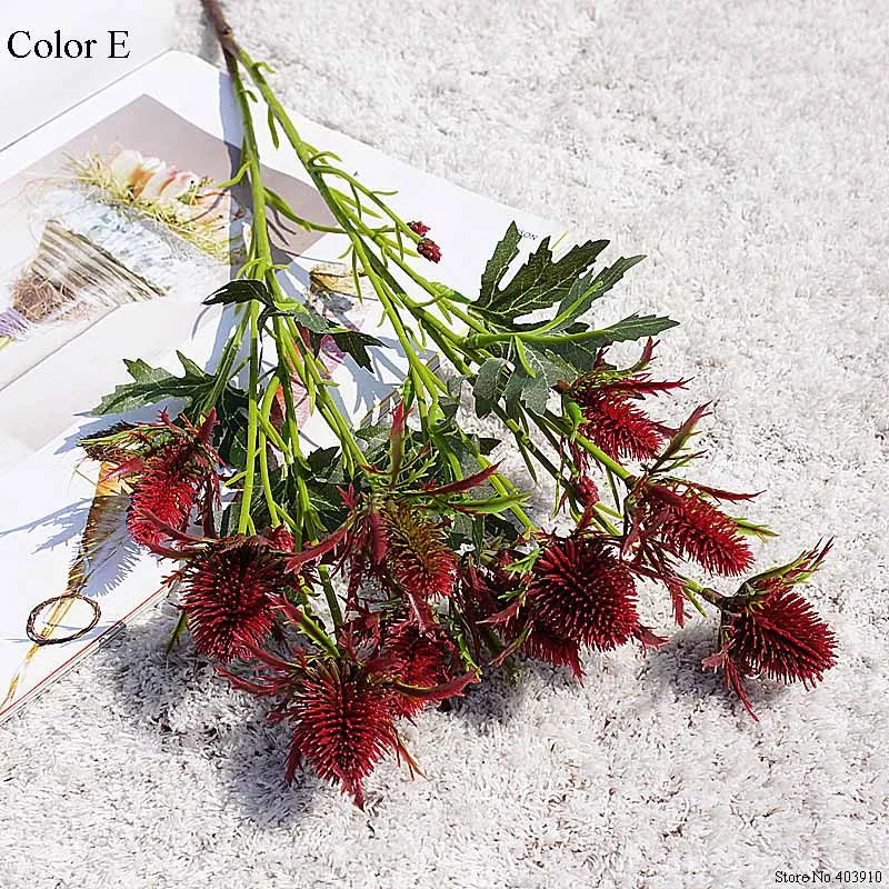 Artificial red and green foliage on a textured surface