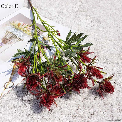 Artificial red and green foliage on a textured surface