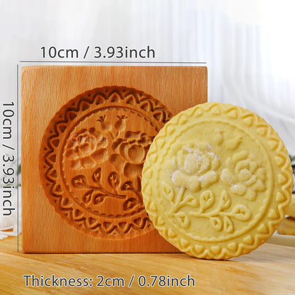 Wooden mold with floral design next to a yellow embossed cookie on a white background