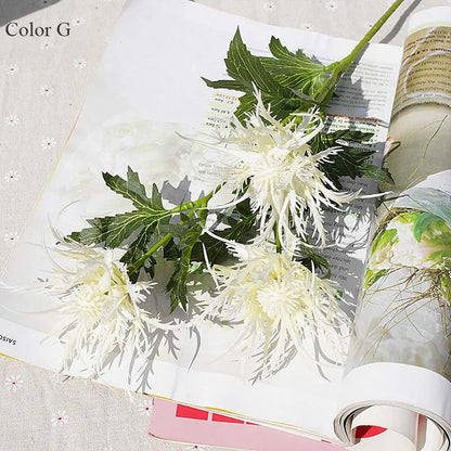 White flowers and green leaves on an open book with a light background