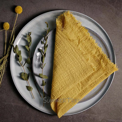 Yellow napkin on a gray plate with decorative elements on a dark surface