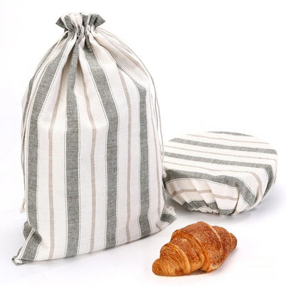 Striped drawstring bag with a croissant on a white background