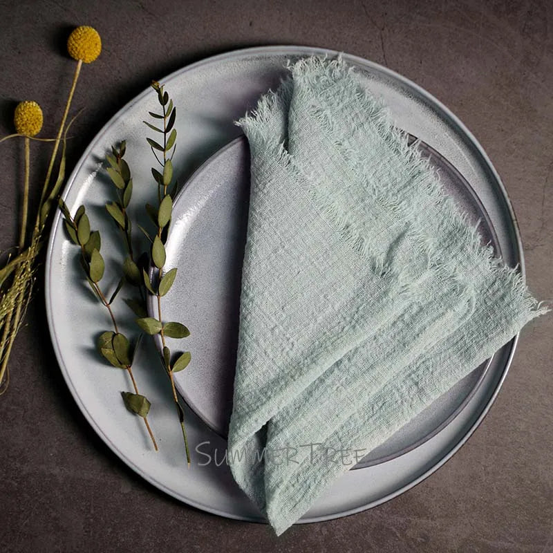 Light green napkin on a gray plate with decorative elements on a dark surface