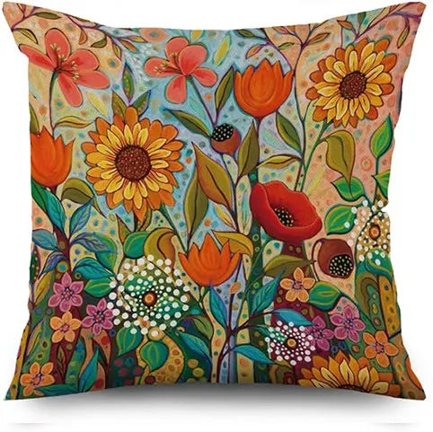 Colorful floral pillow with vibrant flowers and leaves on a white background