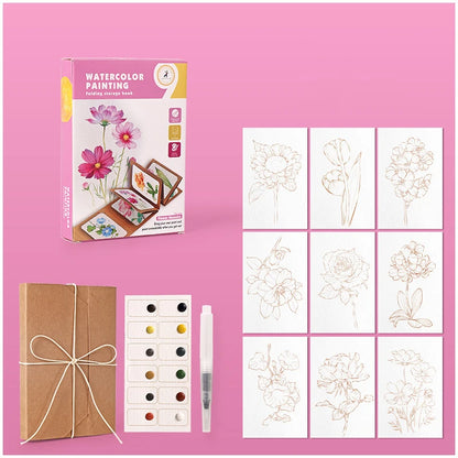 Artistic set with watercolor painting book, cards, and watercolors on a pink background