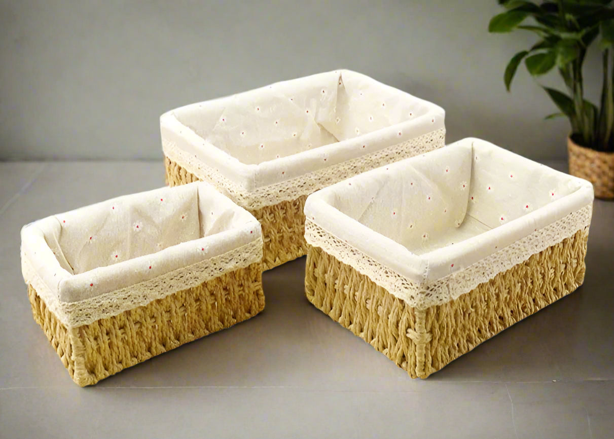 Three woven baskets with white interior on a white background
