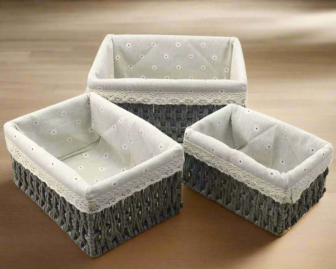 Three woven baskets with gray fabric lining on a white background