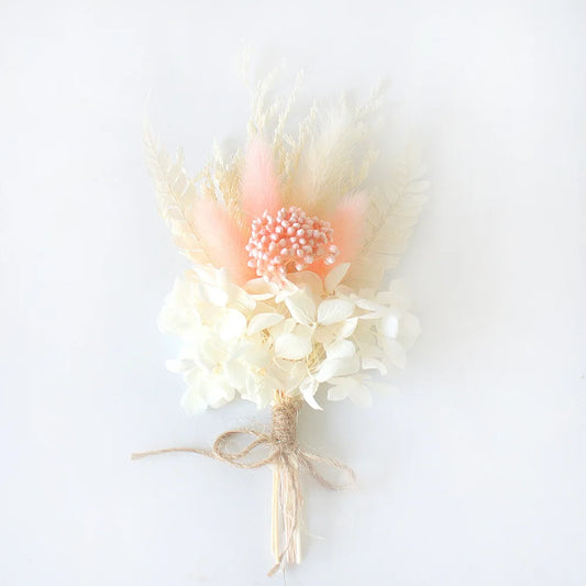 Bouquet of dried flowers with a pink center on a white background