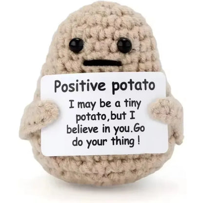 Plush toy resembling a potato with a message card on a white background
