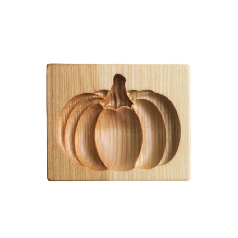 Wooden pumpkin carving block on a white background