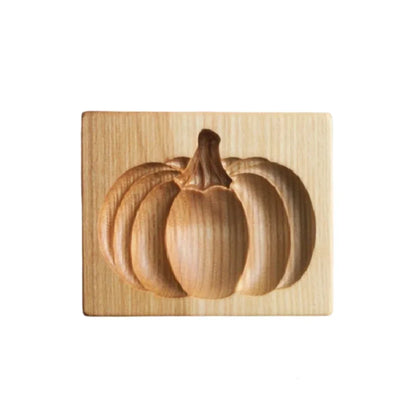 Wooden pumpkin carving block on a white background