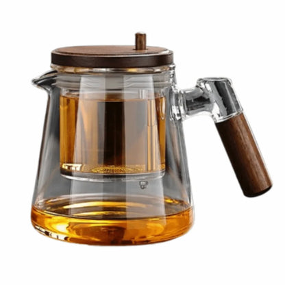 Clear glass teapot with wooden handle and lid on a white background