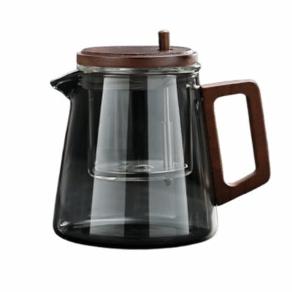 Clear glass teapot with wooden handle and lid on a white background