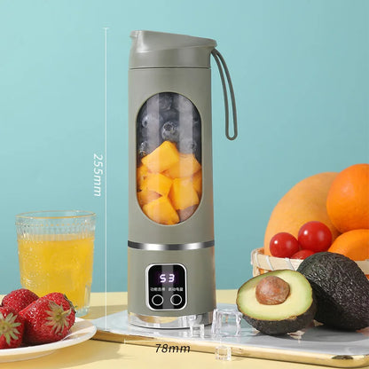 Portable blender with fruits and juice on a light blue background
