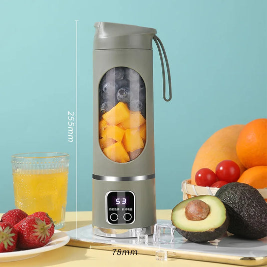 Portable blender with fruits and juice on a light blue background