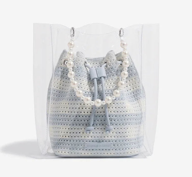 Crocheted bag with pearl details on a white background