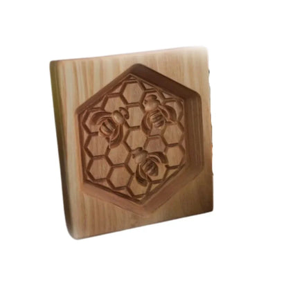 Wooden block with bee and honeycomb design on a white background