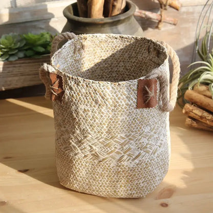 Woven basket with decorative leather patches on a wooden surface