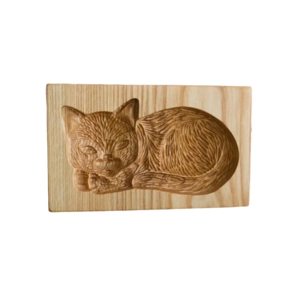Wooden carving of a cat on a wooden block