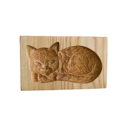Wooden carving of a cat on a wooden block