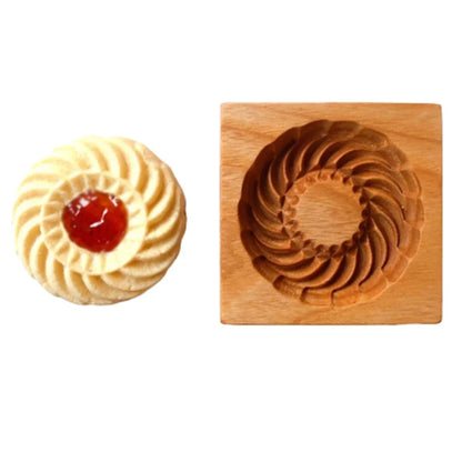 Wooden cookie cutter shaped like a decorative cookie with a white background