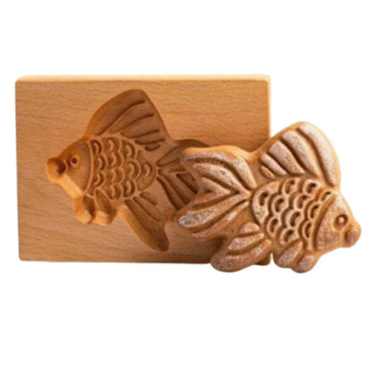 Wooden fish-shaped mold on a white background