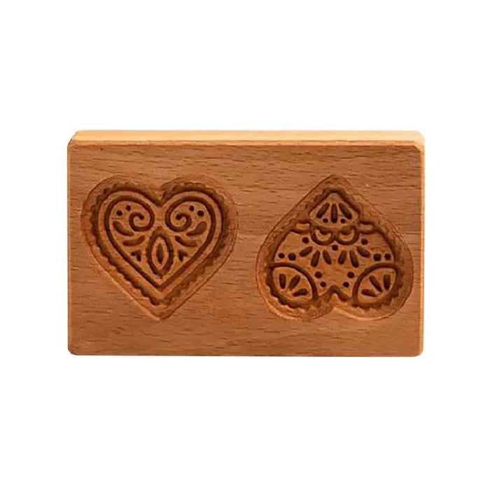 Wooden stamp with two heart-shaped designs on a white background