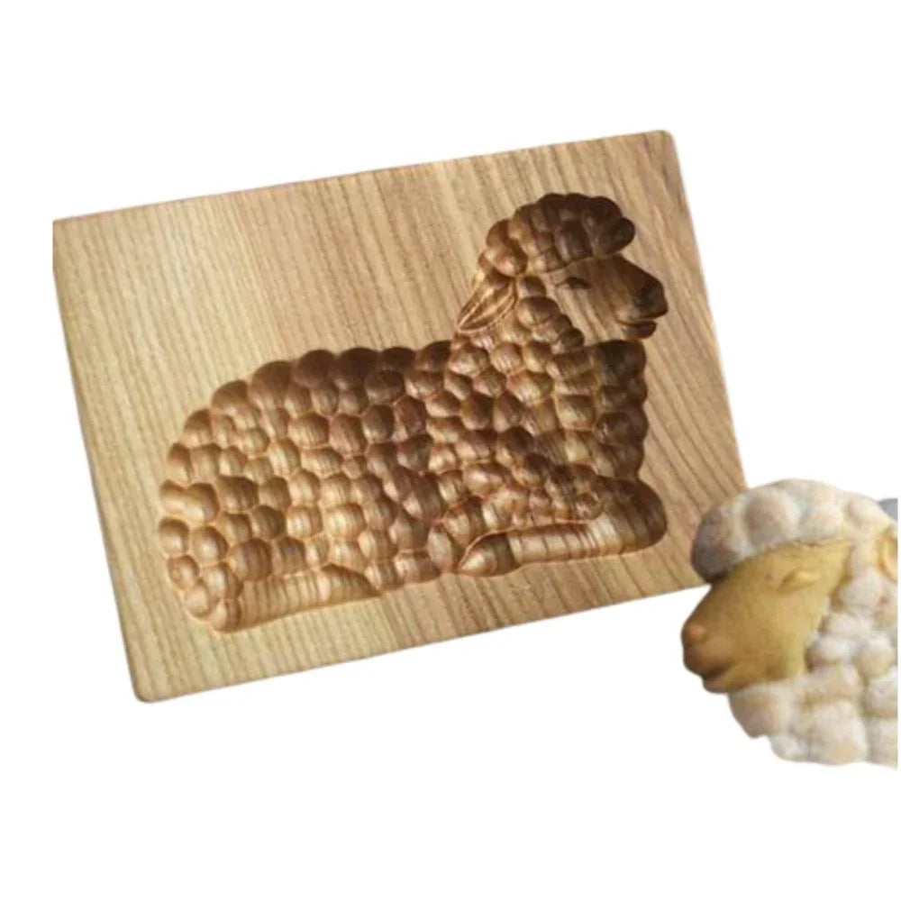 Wooden butter mold with shell design on a white background