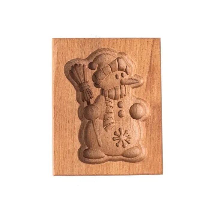 Wooden snowman cookie cutter on a wooden board